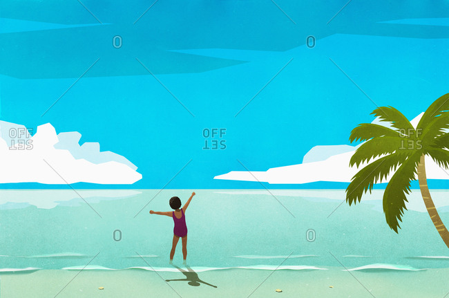 Exuberant woman wading in sunny tropical ocean