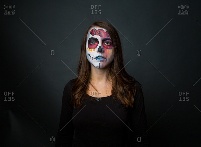 Young woman with creepy face paint