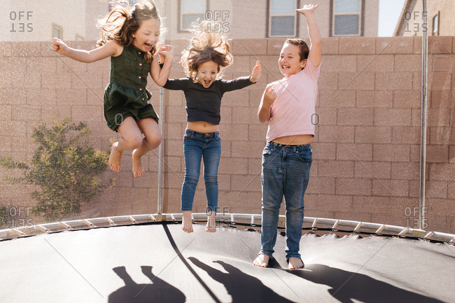 Children jump on trampoline