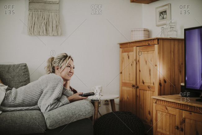 Woman Relaxing On The Couch Watching Tv Stock Photo Offset