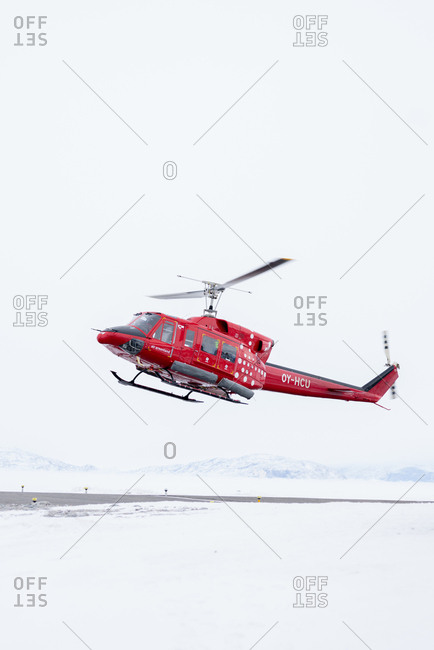Greenland - April 18, 2017: Helicopter preparing to land in Greenland