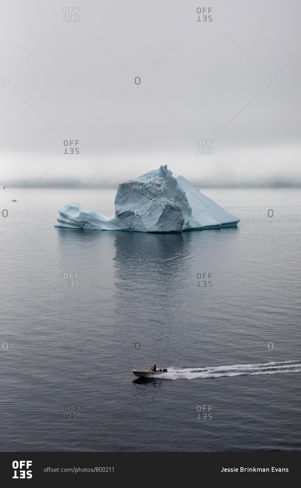 Boat moving past iceberg in the sea