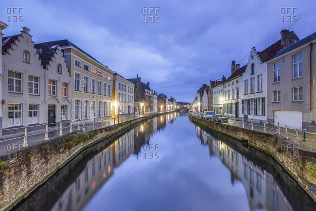 December 2, 2016: Belgium- Bruges- row of houses at canal by twilight