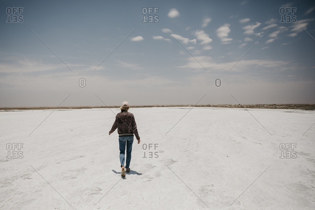 Namibia- Walvis Bay- woman walking on a salt plain