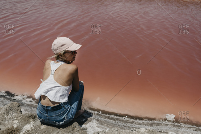 Namibia- Walvis Bay- woman sitting at Pink Lagoons
