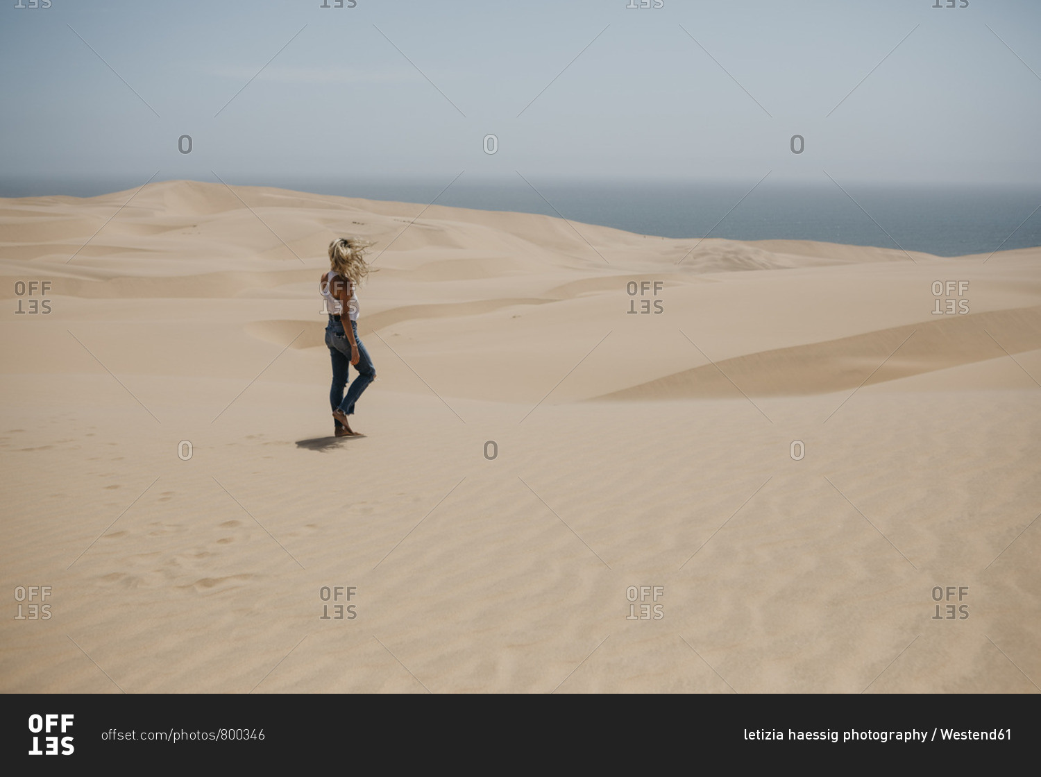 Namibia- Walvis Bay- Namib-Naukluft National Park- Sandwich Harbour- woman walking in dune landscape
