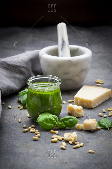 Glass of homemade pesto Genovese and ingredients