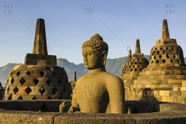 Indonesia- Java- Borobudur Temple Complex- Buddha sitting in a stupa