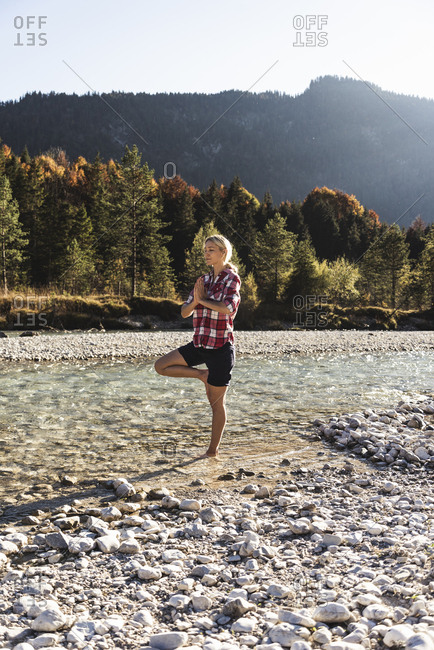 Austria- Alps- woman practicing yoga in a mountain brook