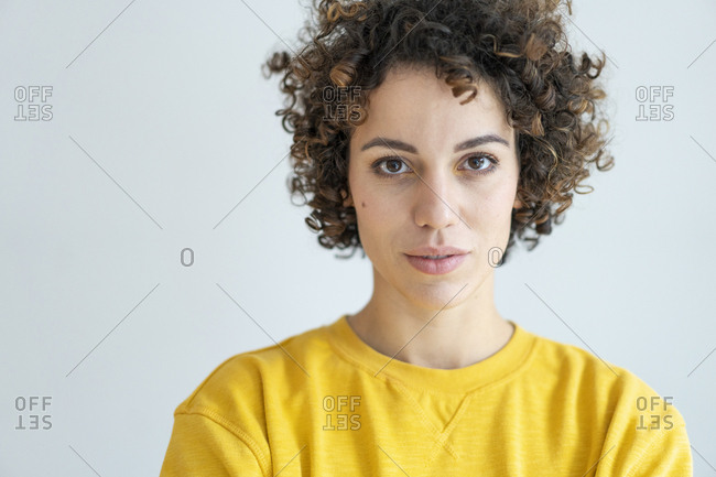 Portrait of confident woman wearing yellow sweater