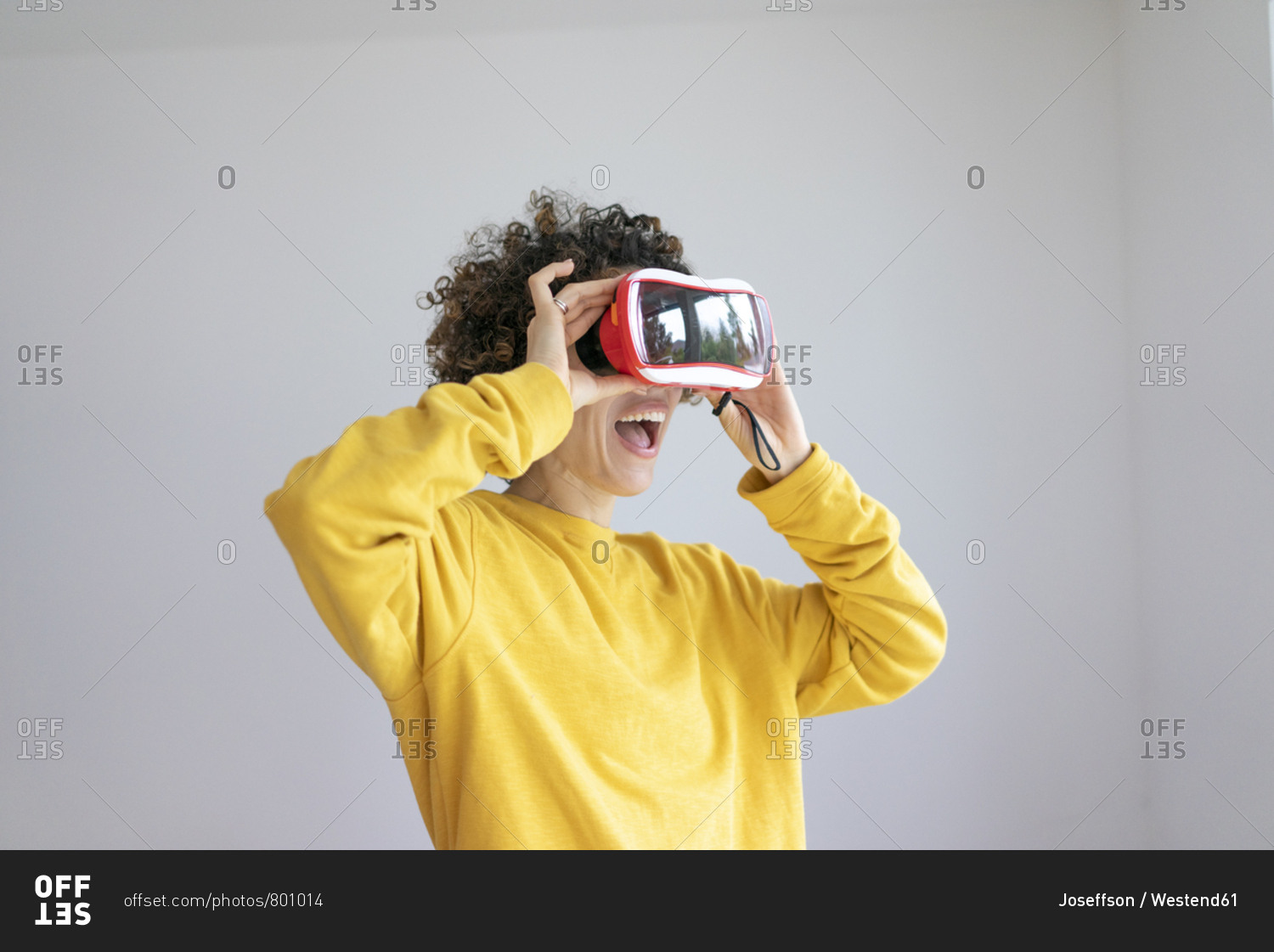 Excited woman wearing VR glasses