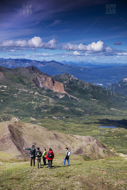 June 29, 2015: USA, Alaska, Denali, Denali National Park, individuals explore around the Alaskan backcountry with experienced local naturalist Jeffery Ottners during a Helihiking tour, Cool Mountain