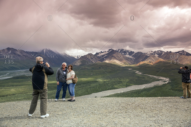 June 29, 2015: USA, Alaska, Denali, Denali National Park, guests pose for photographs during a break on the wildlife viewing drive tour through the park