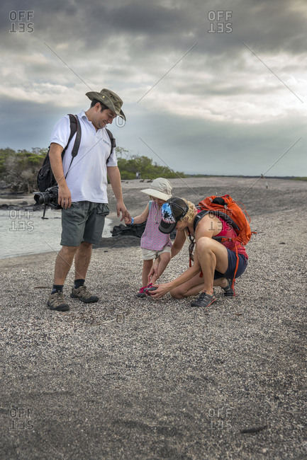 March 23, 2014: GALAPAGOS ISLANDS, ECUADOR, individuals walking on the beach on Fernandina Island