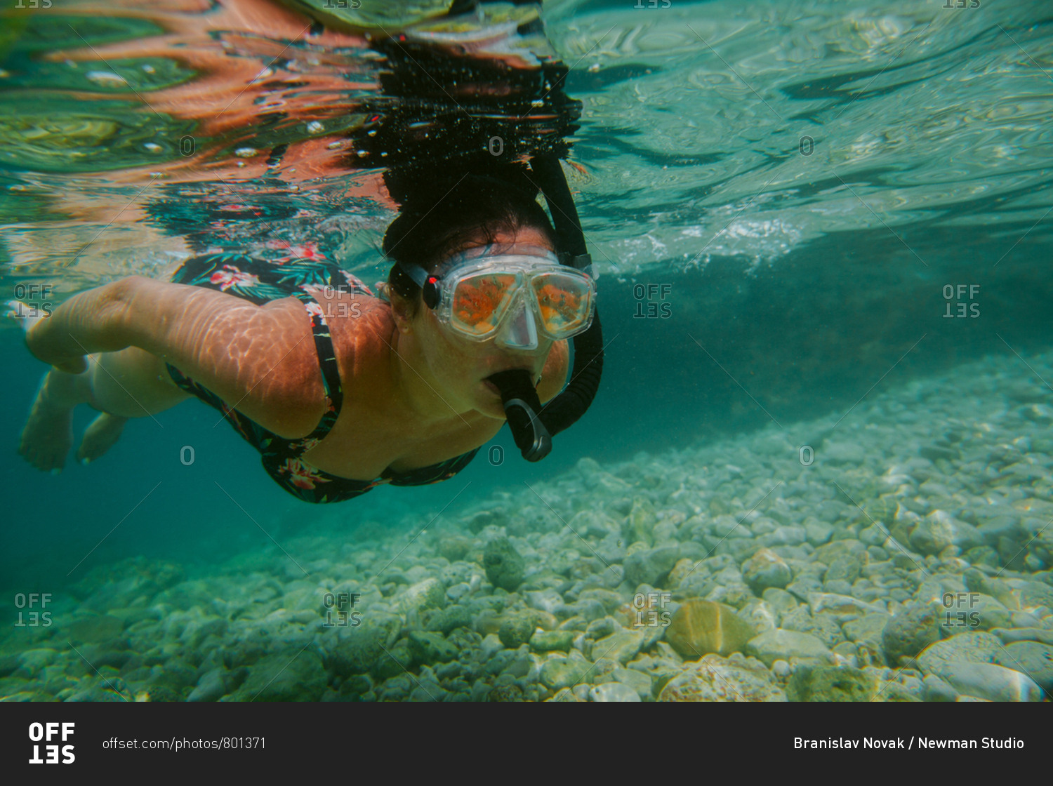 Woman snorkeling. Female diver wearing diving mask and snorkel swimming