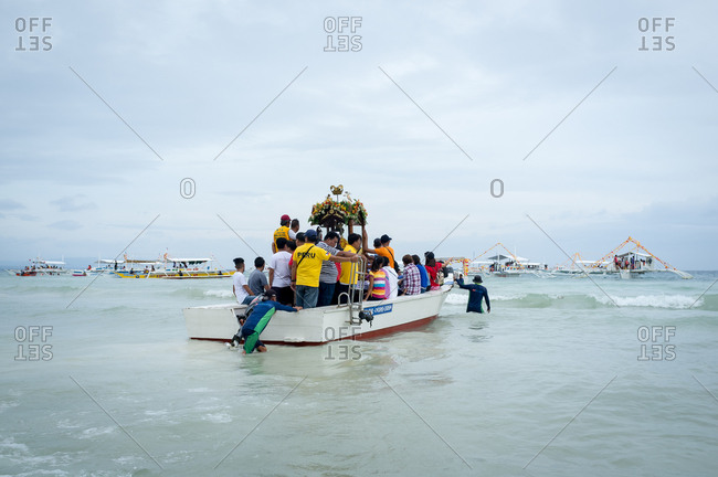 January 26, 2019: People placing the image of The Santo Nino on a boat. Panglao Island, Bohol, Philippines