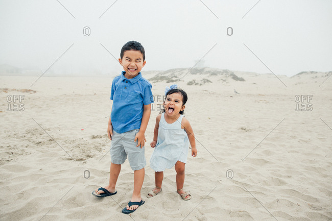 Silly Faces From Siblings At The Foggy Beach