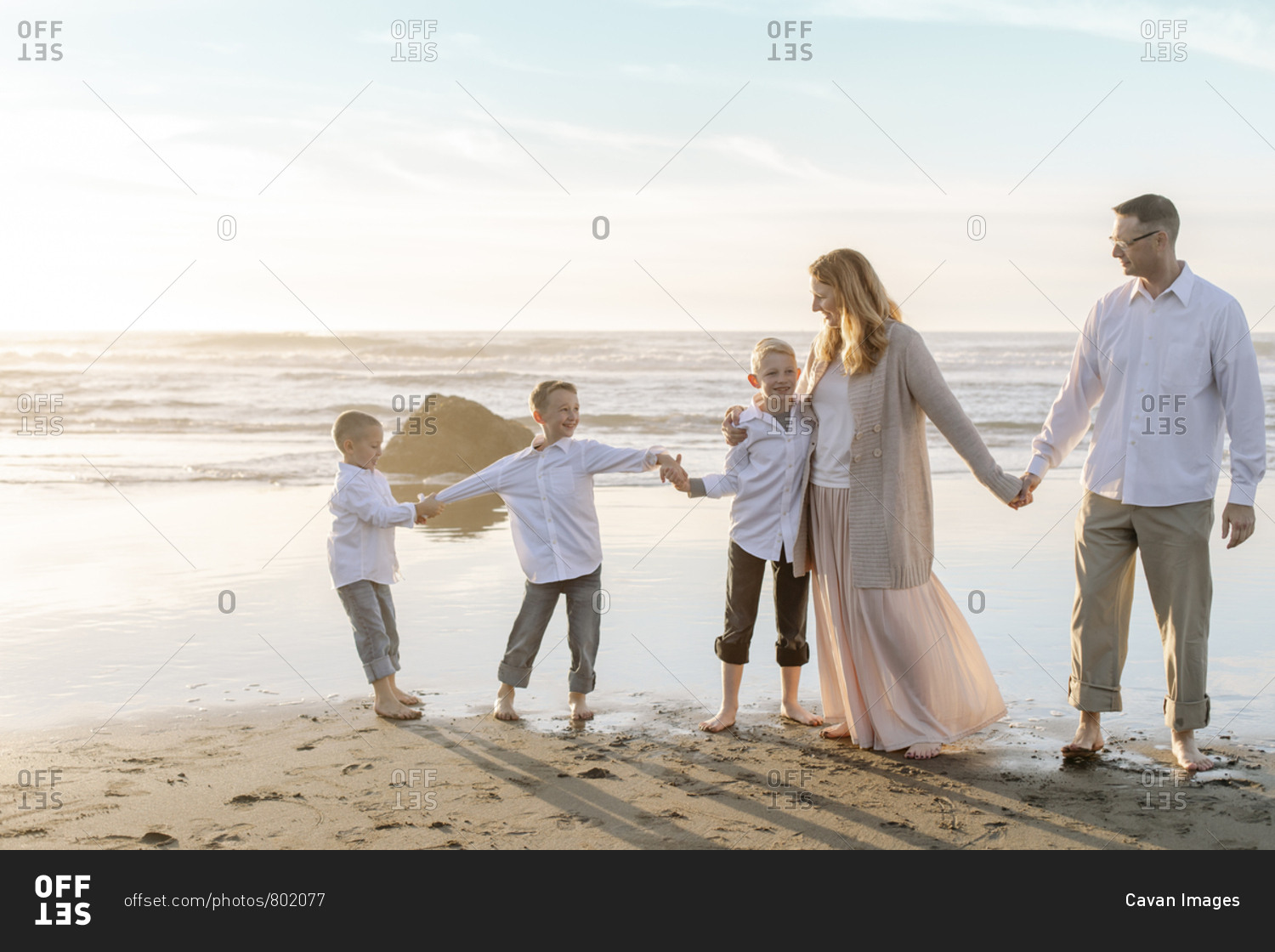 Portrait of family holding hands on bright sky