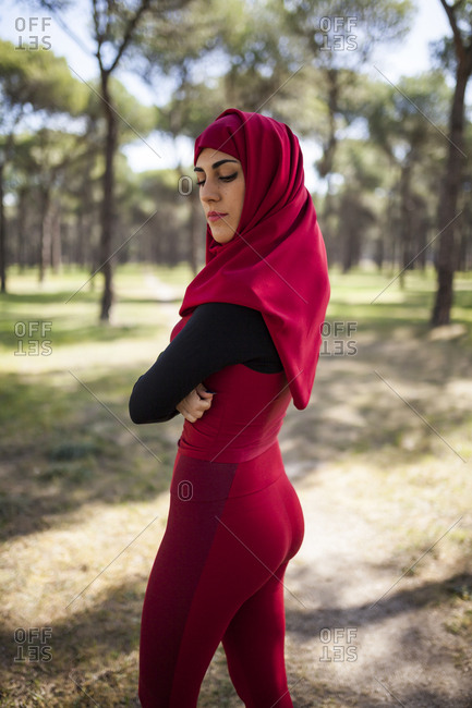 Muslim woman posing dressed in maroon running sportswear