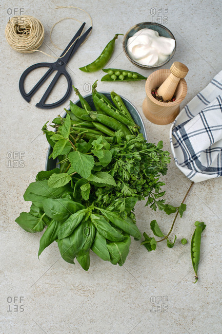 Variety of greens on the table by scissors and twine