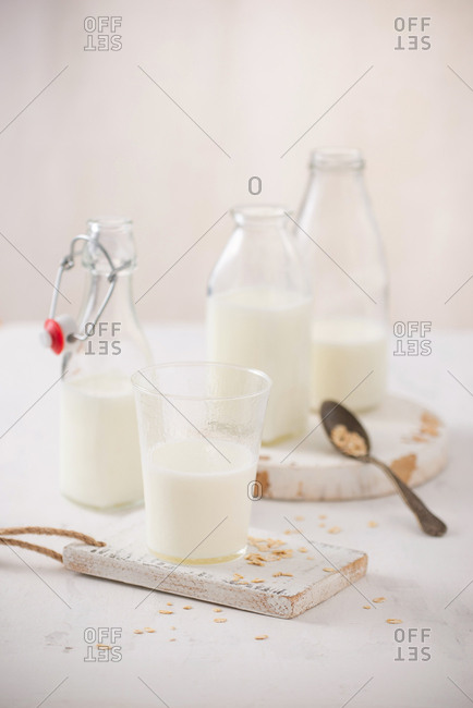 fresh milk in glass jar and glass on wooden background