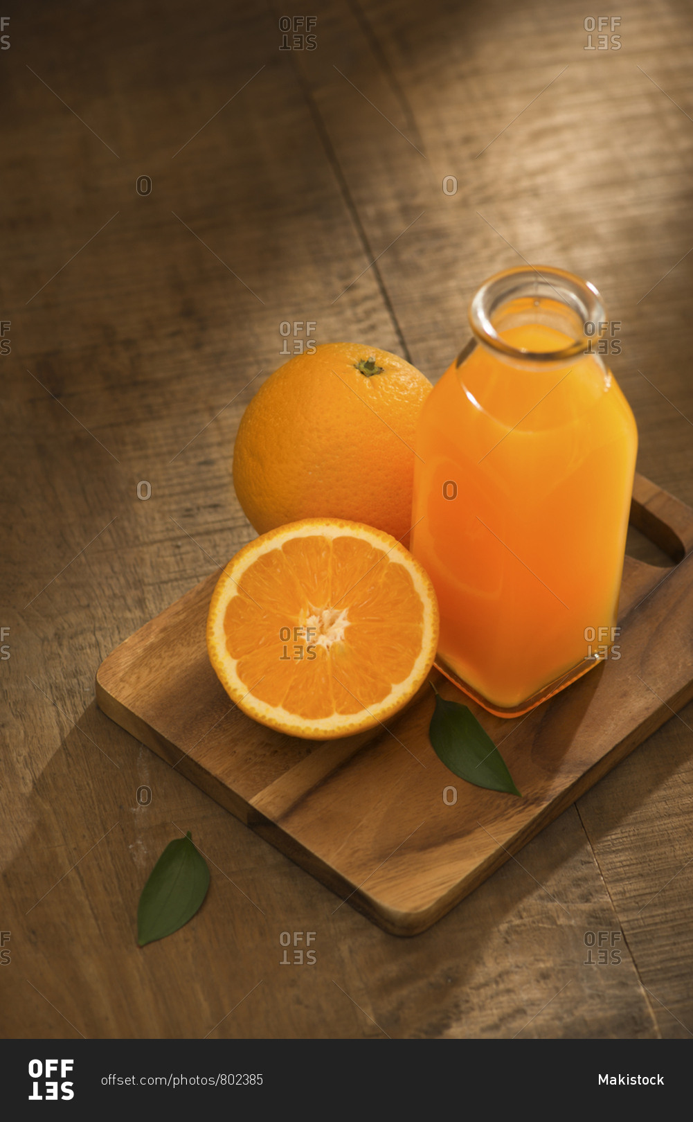 Glass of orange juice from above on wood table. Empty ready for