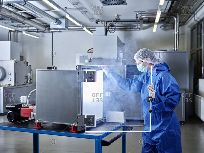 Chemist working in industrial laboratory clean room