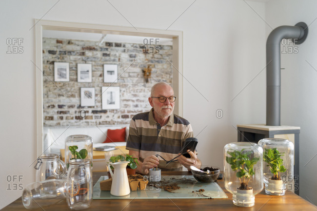 Senior man making glass biotopes at home