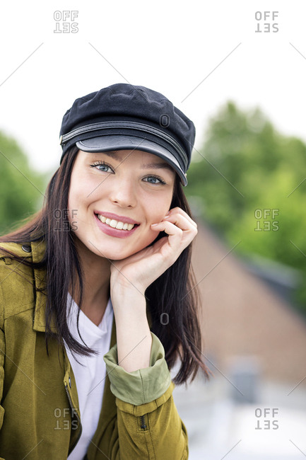 Portrait of a young woman with cap- smiling