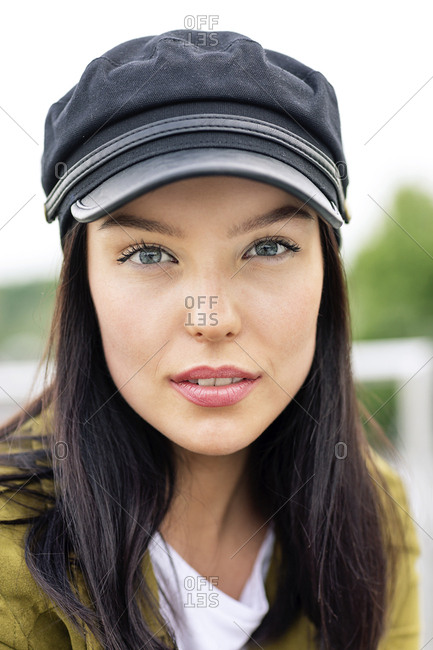 Portrait of a young woman with cap- looking cool