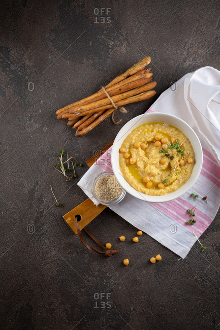 Bowl of hummus on a wooden board