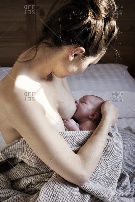 Mother breastfeeding newborn baby - Offset