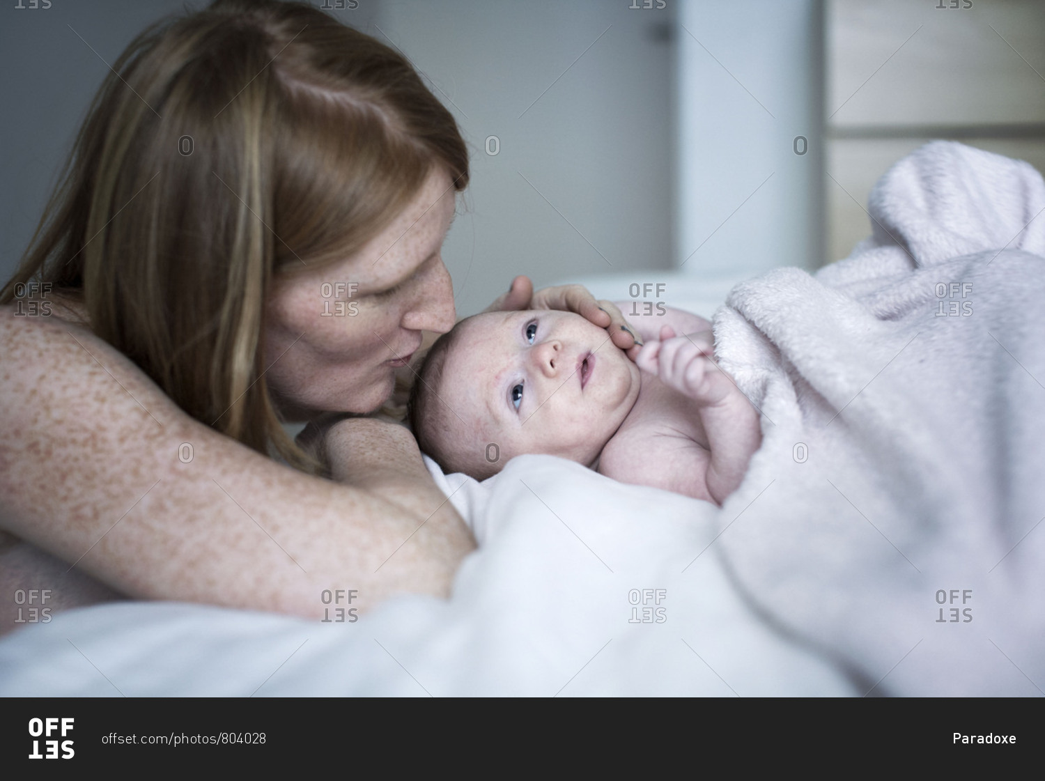 Mother comforting newborn baby