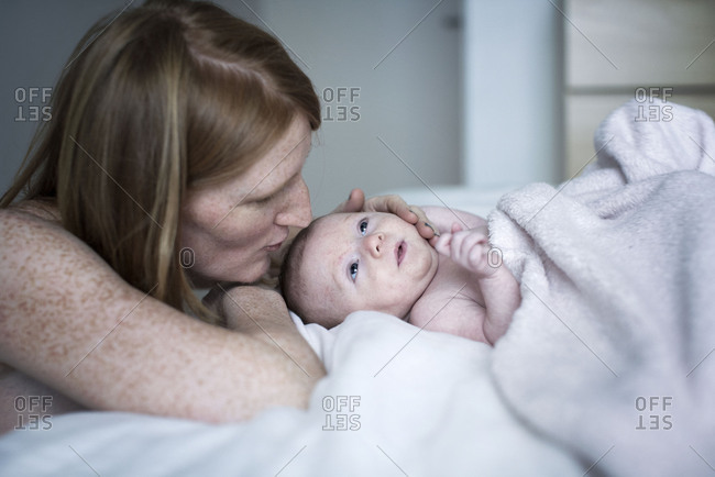 Mother comforting newborn baby - Offset
