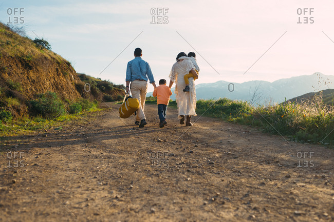 Family walking on hillside path