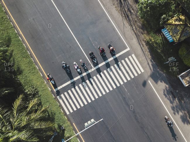 Indonesia- Bali- Sanur- Aerial view of motorbikes waiting at zebra crossing on the road