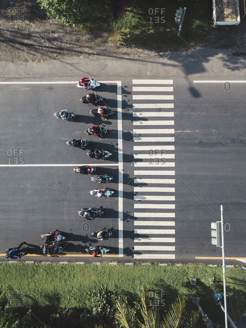 Indonesia- Bali- Sanur- Aerial view of motorbikes waiting at zebra crossing on the road