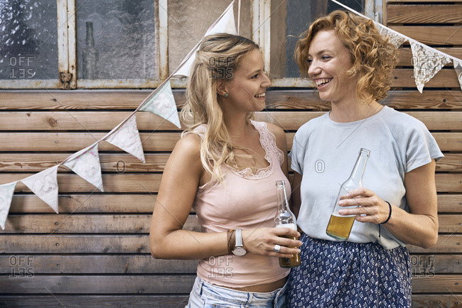 Friends having fun at a barbecue party- drinking beer