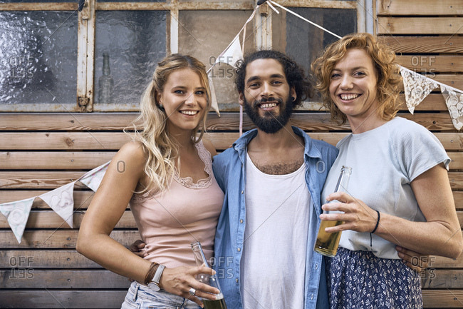 Friends having fun at a barbecue party- drinking beer