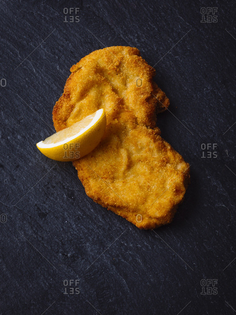 Wiener Schnitzel and lemon slice on slate