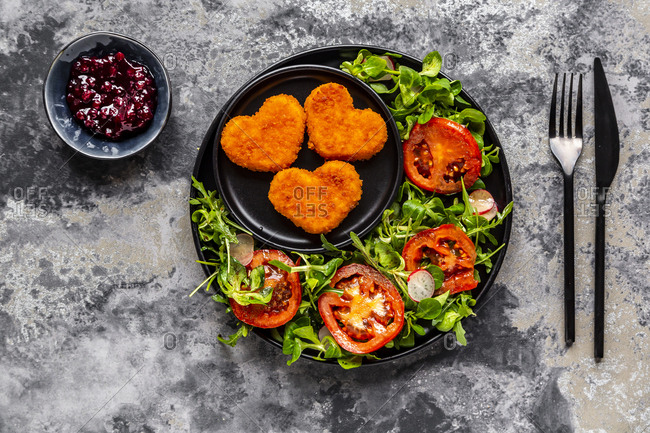Baked camembert in heart shape with rocket- lamb's lettuce- tomato- radish and lingonberry