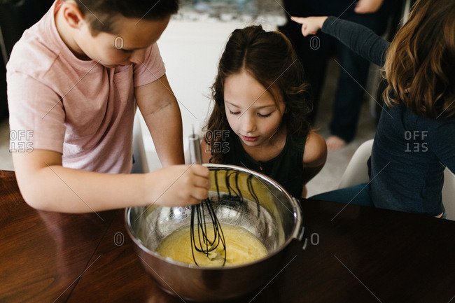 Kids mixing brownies and baking