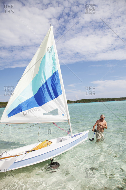 October 29, 2011: EXUMA, Bahamas. Yves, the Resort Manager, going sailing at the Fowl Cay Resort.