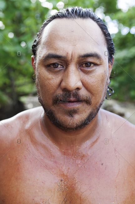 April 14, 2010: FRENCH POLYNESIA, Moorea. Portrait of man after swimming in the ocean.