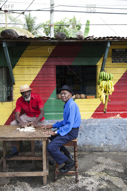 January 31, 2012: JAMAICA, Port Antonio. Joseph "Powder" Bennett and Derrick "Johnny" Henry of the Mento band, The Jolly Boys playing dominoes at the Willow Wind Bar.
