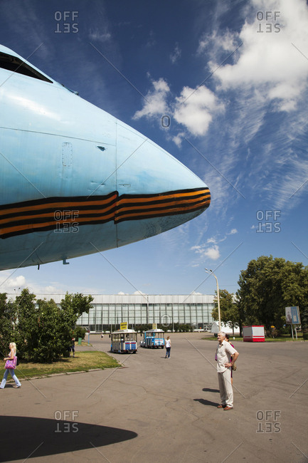 July 6, 2011: RUSSIA, Moscow. A visitor looking at a plane on display at the All-Russia Exhibition Center.