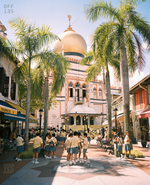 June 21, 2010: SINGAPORE, school children playing in front of Masjid Sultan Singapore Mosque