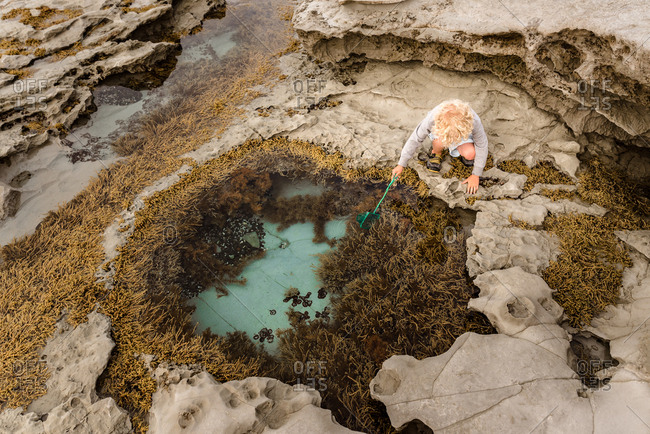 Boy exploring the contents of a ride pool
