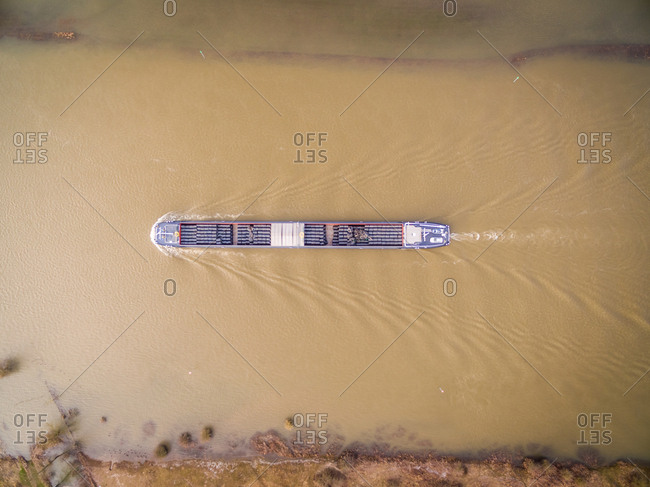 Aerial view of cargo boat transporting goods on river, Olst, Netherlands.