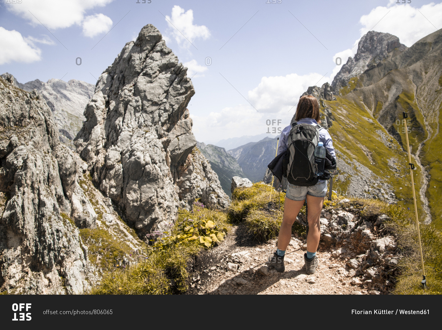Austria- Tyrol- woman on a hiking trip in the mountains looking at view
